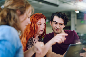 Unposed group of creative business people in an open concept office brainstorming their next project
