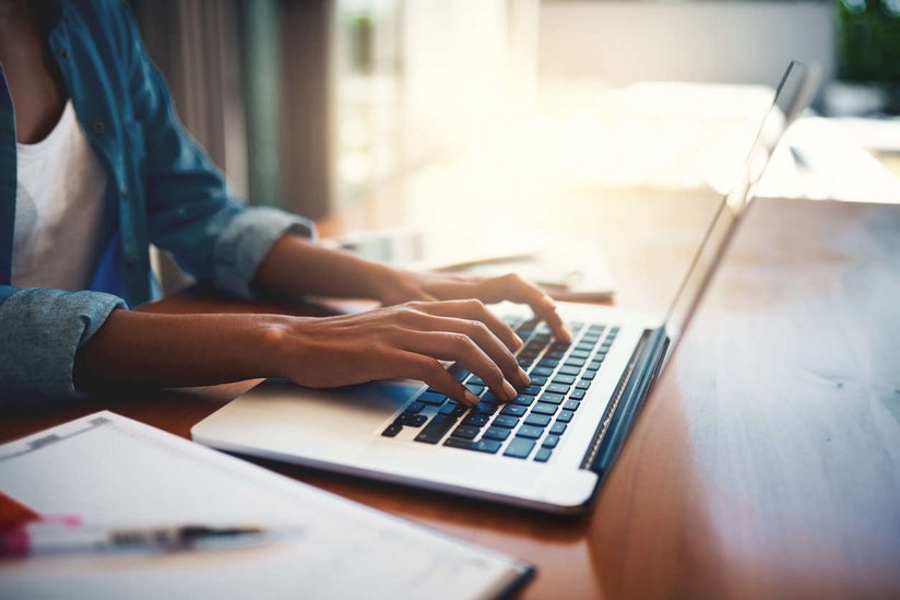woman sitting at a table using her computer.jpg